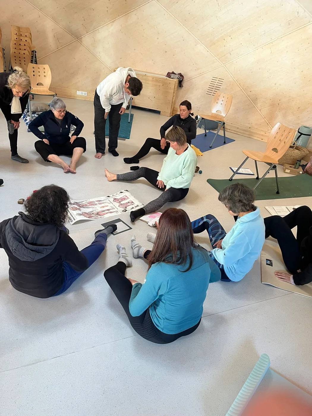 Groupe en pratique de Do In dans une salle lumineuse.